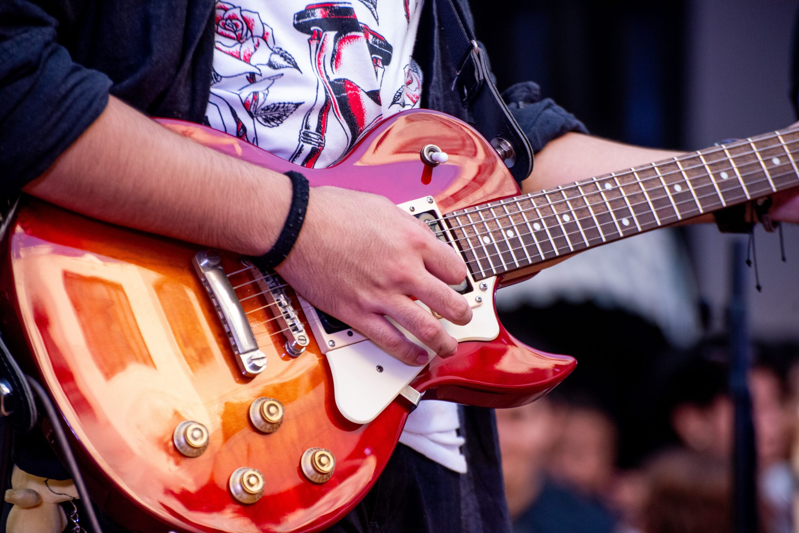 Close-up of a guitarist's hand and guitar while performing.